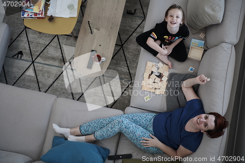 Image of mother and daughter at home playing memory game