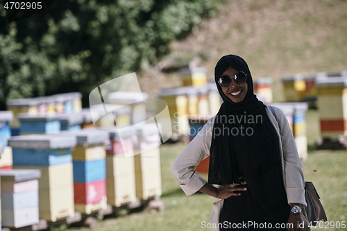 Image of african muslim businesswoman portrait on small local honey production farm