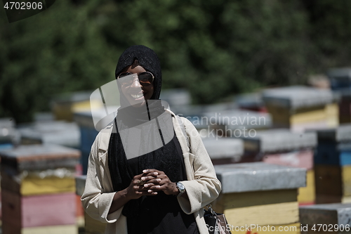 Image of african muslim businesswoman portrait on small local honey production farm