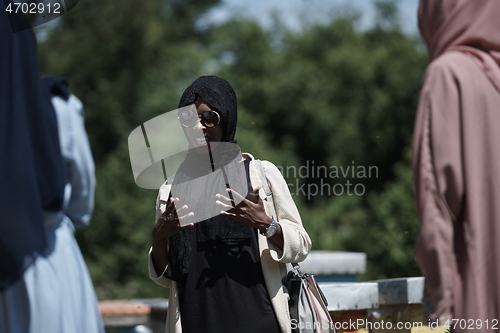 Image of woman giving presentation to group of business investors on local honey production farm