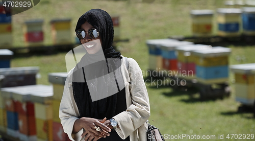 Image of african muslim businesswoman portrait on small local honey production farm