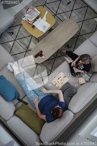 Image of mother and daughter at home playing memory game