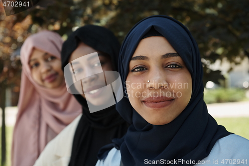 Image of businesswoman group portrait wearing traditional islamic clothes