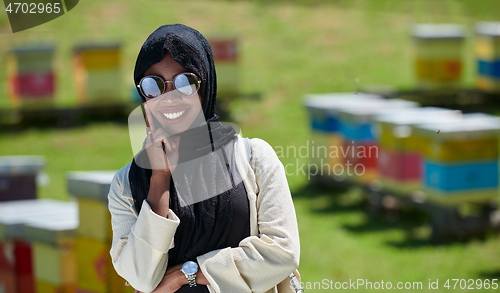 Image of african muslim businesswoman portrait on small local honey production farm