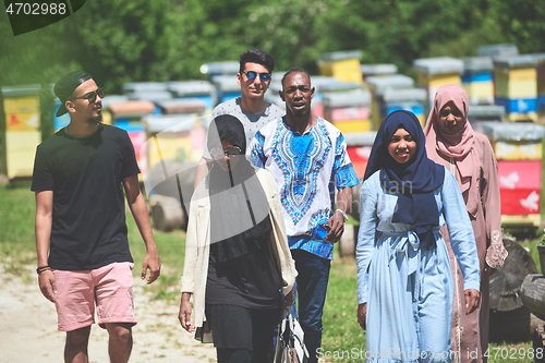 Image of people group visiting local honey production farm