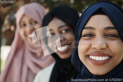 Image of businesswoman group portrait wearing traditional islamic clothes