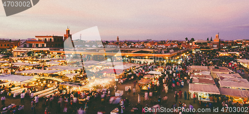 Image of Jamaa el Fna, Marrakesh, Morocco in colorful sunset.