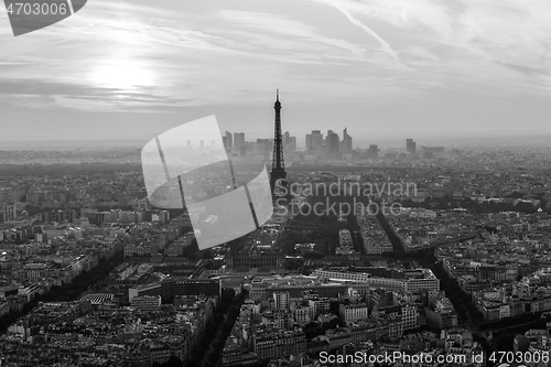 Image of Aerial view of Paris with Eiffel tower and major business district of La Defence in background at sunset