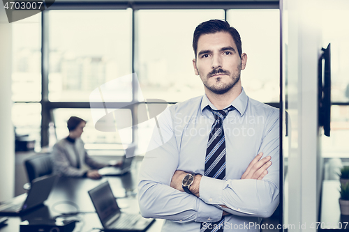 Image of Team leader with coworkers working in office.