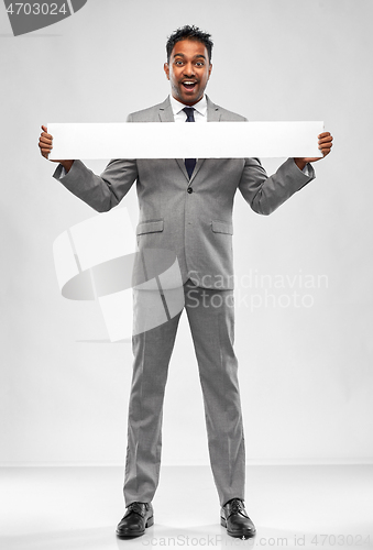 Image of happy indian businessman with white banner