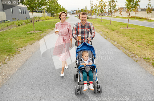 Image of family with baby in stroller and coffee in city