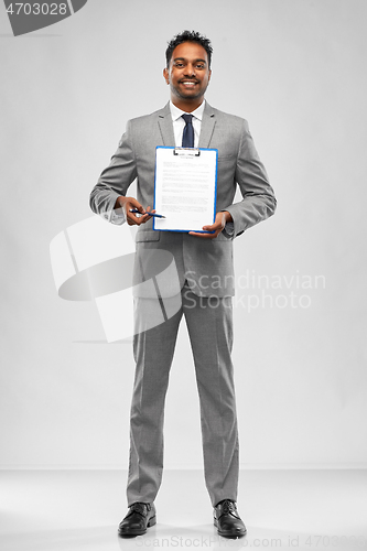 Image of indian businessman with contract on clipboard