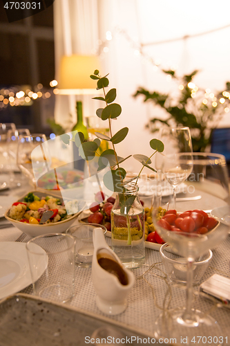 Image of table served with plates, wine glasses and food