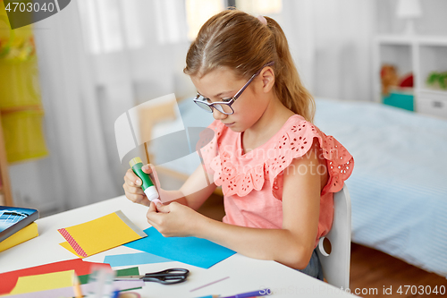 Image of creative girl making greeting card at home