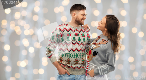 Image of happy couple at christmas ugly sweater party