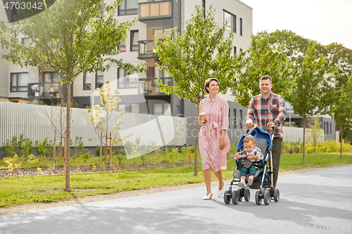 Image of family with baby in stroller and coffee in city