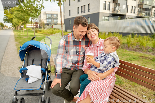 Image of family with baby in stroller and coffee in city