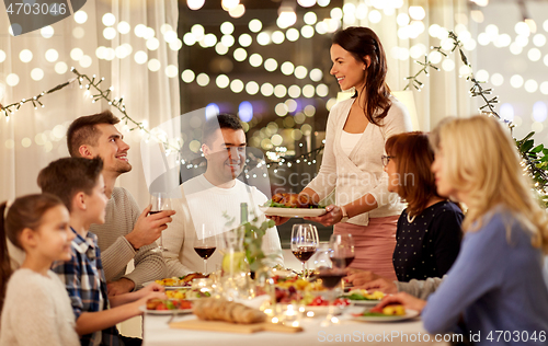 Image of happy family having dinner party at home