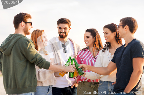 Image of friends toasting non alcoholic drinks on beach