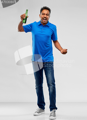 Image of male fan with beer bottle celebrating victory