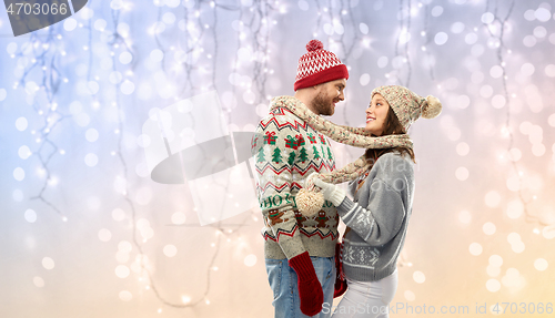 Image of happy couple at christmas ugly sweater party