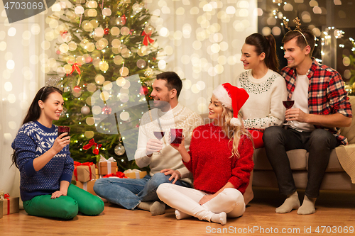 Image of friends celebrating christmas and drinking wine