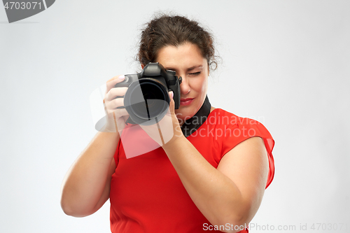 Image of happy woman photographer with digital camera