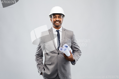 Image of indian male architect in helmet with blueprints