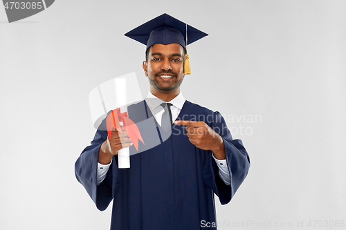 Image of male graduate student in mortar board with diploma