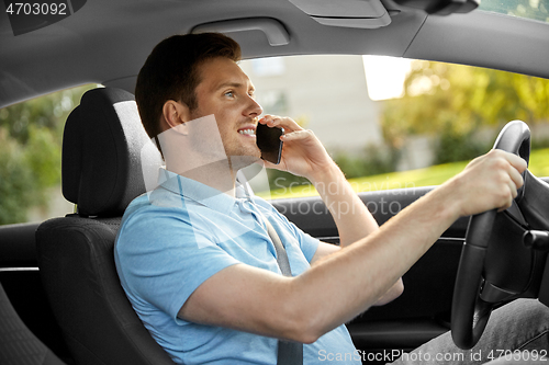 Image of man driving car and calling on smartphone