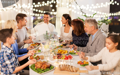 Image of happy family having dinner party at home