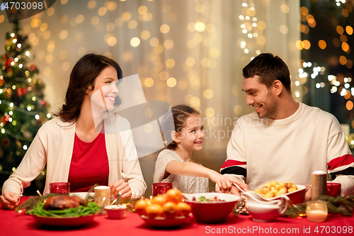 Image of happy family having christmas dinner at home