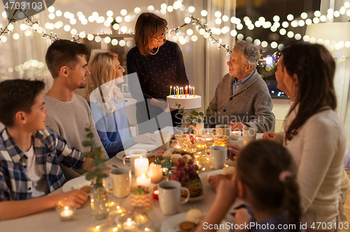 Image of happy family having birthday party at home