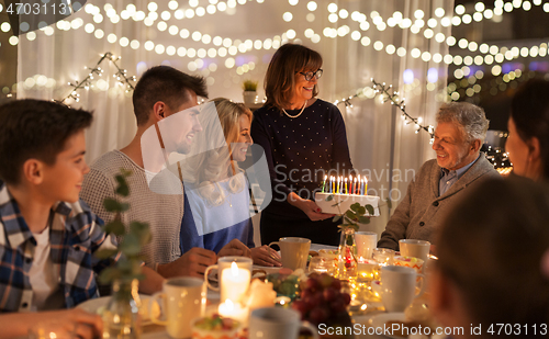 Image of happy family having birthday party at home