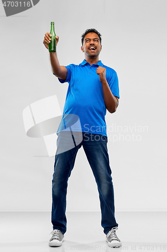 Image of male fan with beer bottle celebrating victory