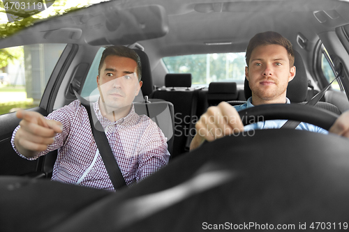 Image of car driving school instructor teaching male driver