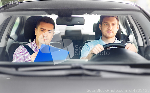 Image of car driving school instructor and young driver