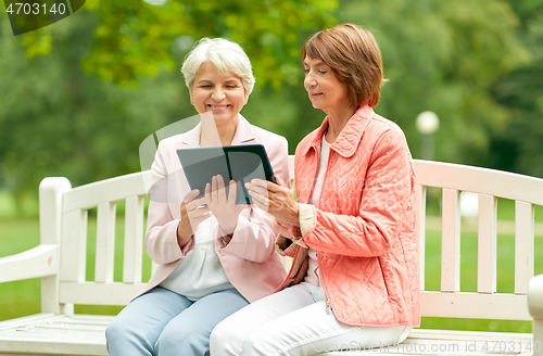 Image of senior women with tablet pc at summer park