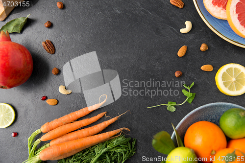 Image of different vegetables and fruits on on slate table