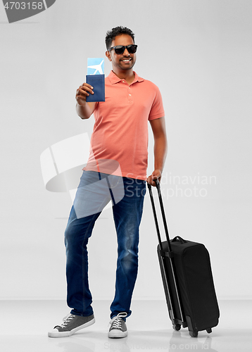 Image of indian man with travel bag passport and air ticket