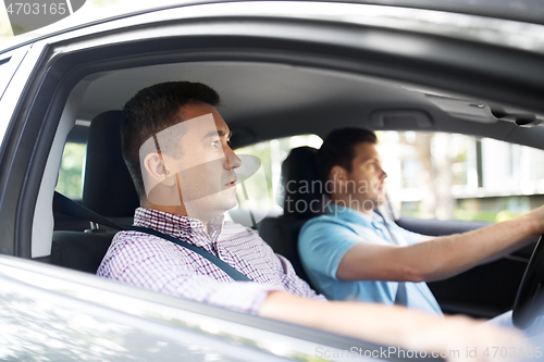 Image of car driving school instructor and male driver