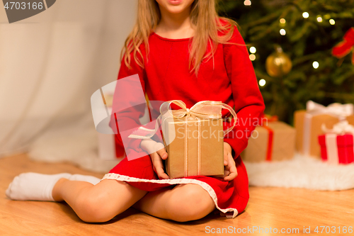 Image of close up of girl with christmas gift at home