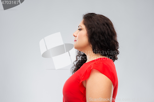 Image of woman in red dress over grey background