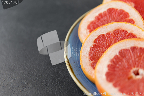 Image of close up of fresh juicy grapefruits on plate