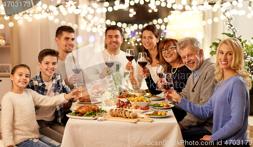 Image of happy family having dinner party at home