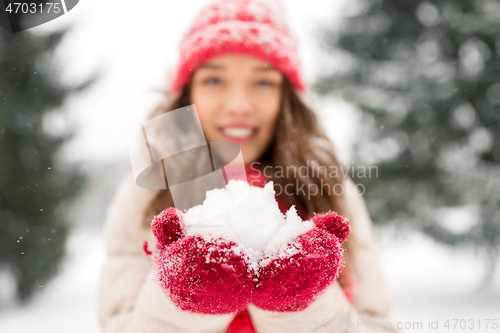 Image of portrait of young woman with snow in winter