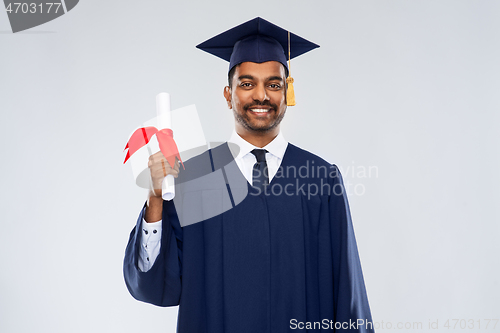 Image of male graduate student in mortar board with diploma