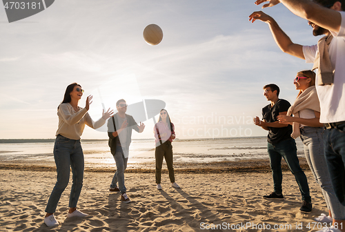 Image of friends playing volleyball on beach in summer