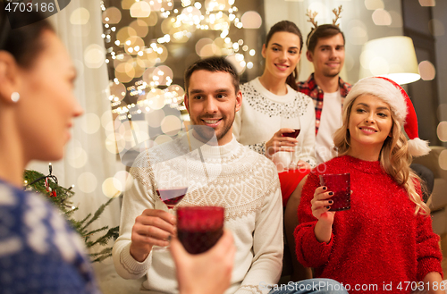 Image of friends celebrating christmas and drinking wine