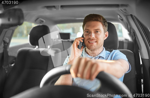 Image of man driving car and calling on smartphone